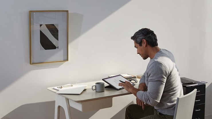 MSFT A man works from his home office with Surface Pen and Surface Pro RWFTdA | Braintree