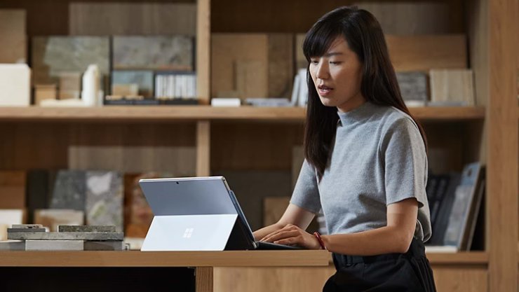 MSFT A person works on their Surface device in an office space RWFINg | Braintree