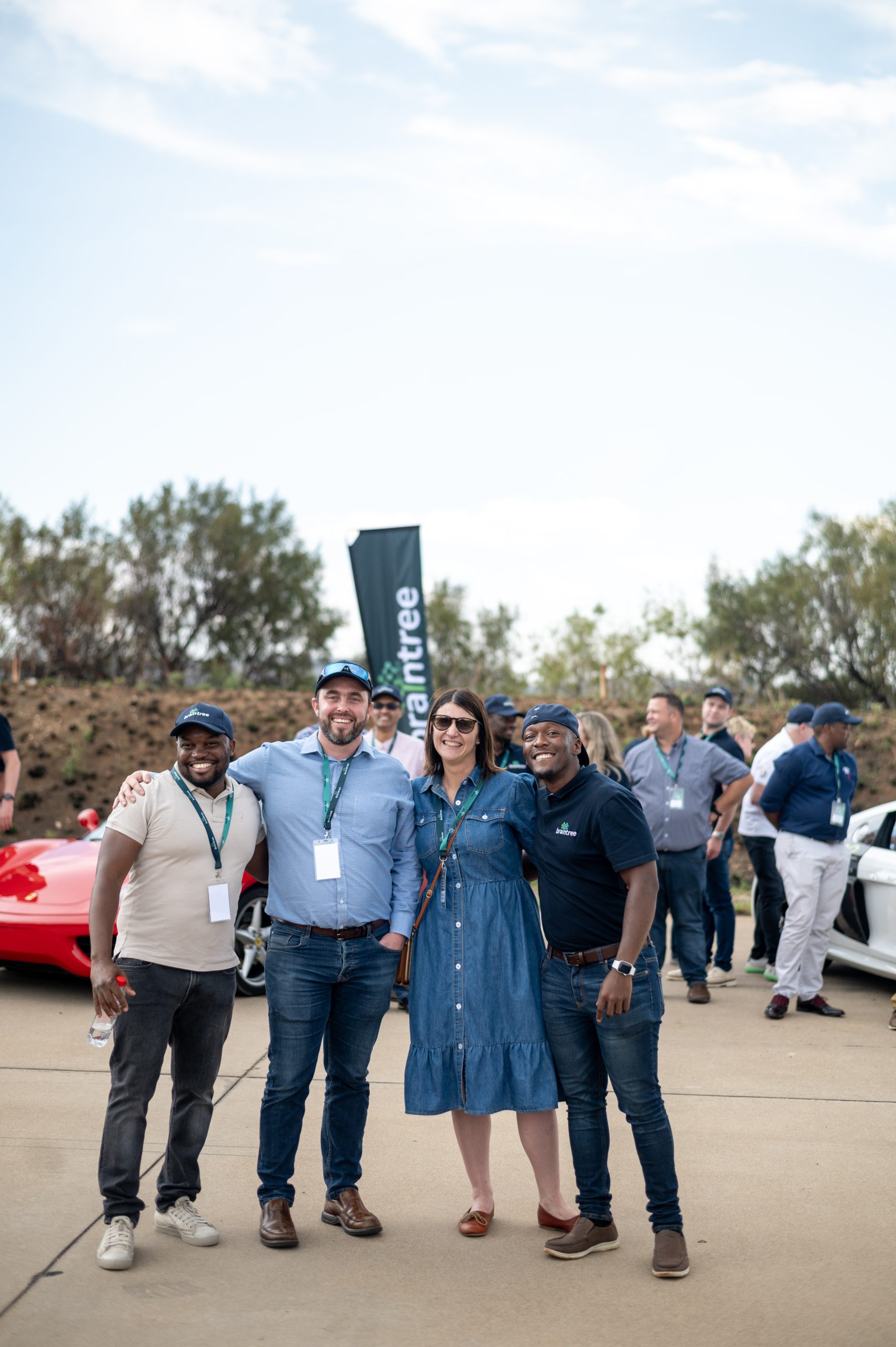 Braintree employees standing in front of supercars - 5