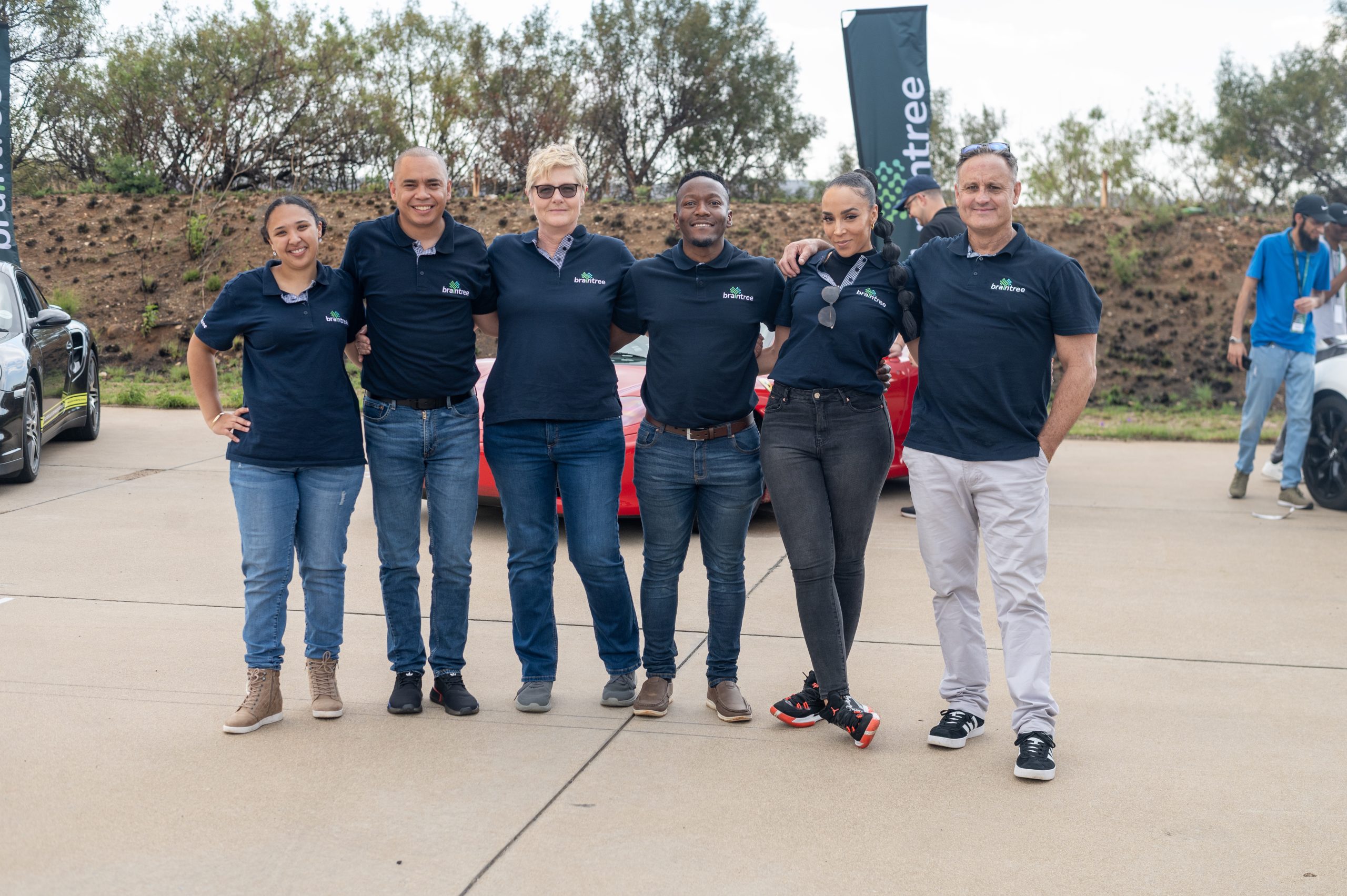 Braintree employees standing in front of supercars - 4